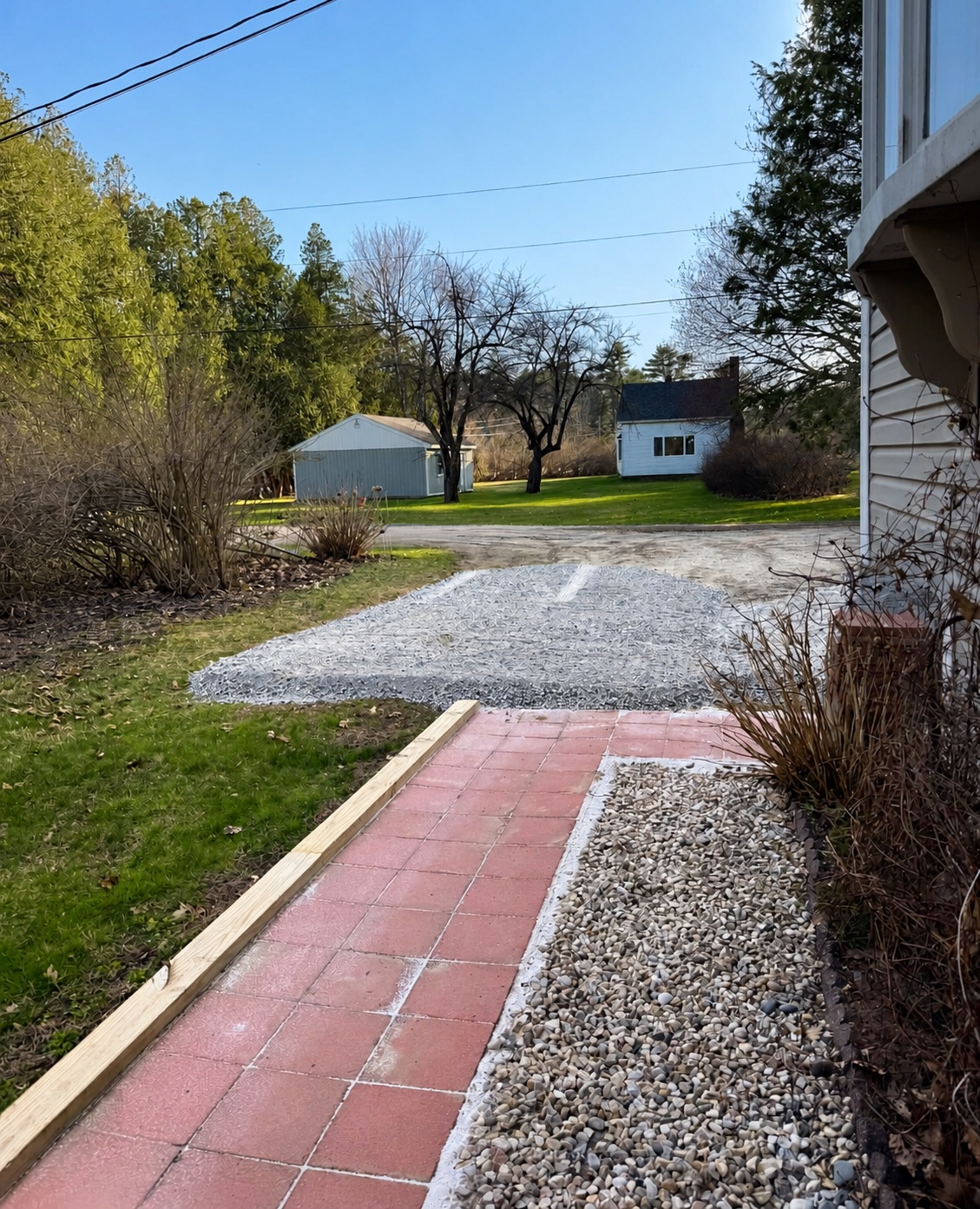 Finished gravel driveway and bordered walkway